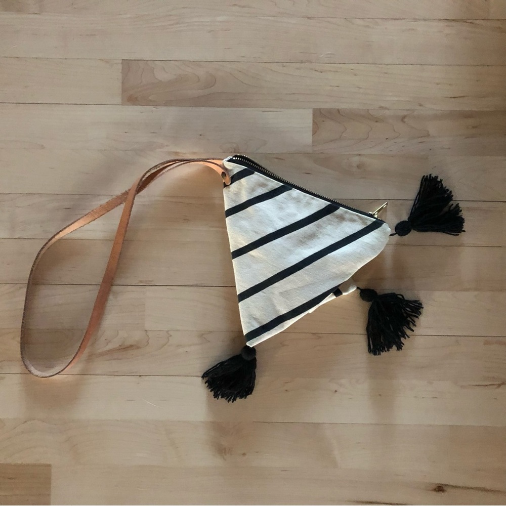 Triangle canvas zipper bag with tassels and a leather strap. Printed stripes